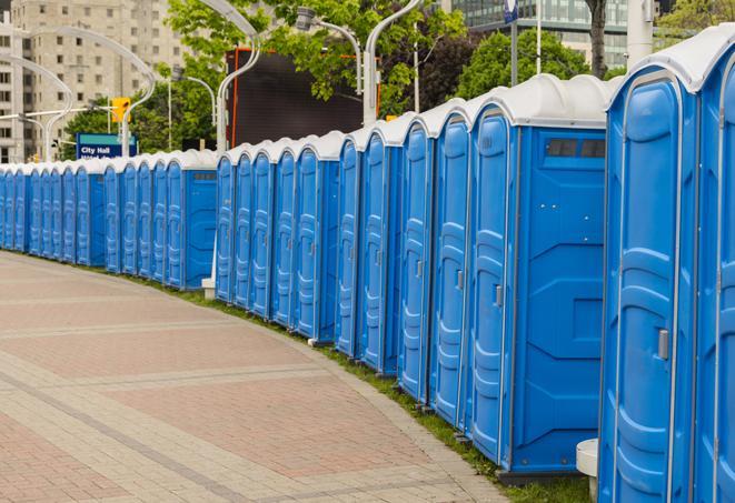 a line of portable restrooms at a sporting event, providing athletes and spectators with clean and accessible facilities in Dinuba